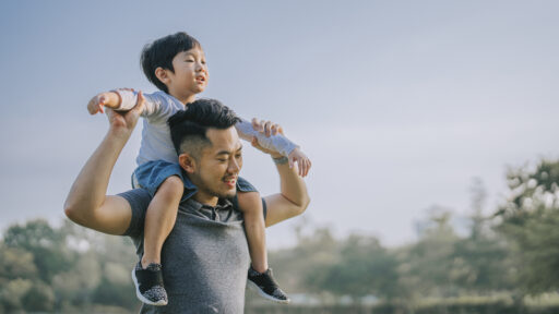 dad with his son on his shoulder