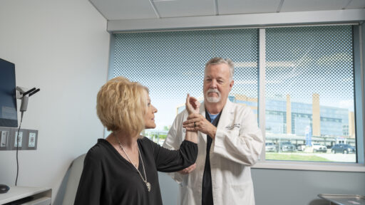 Doctor helping a patient with shoulder pain