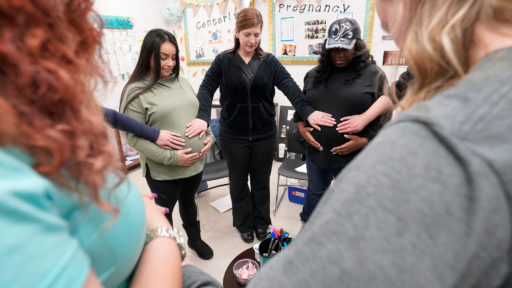 Pregnant women and doctor gathered in a circle.