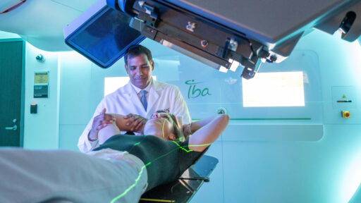 Dr. Sanjay Maraboyina with a patient in the Proton Center of Arkansas