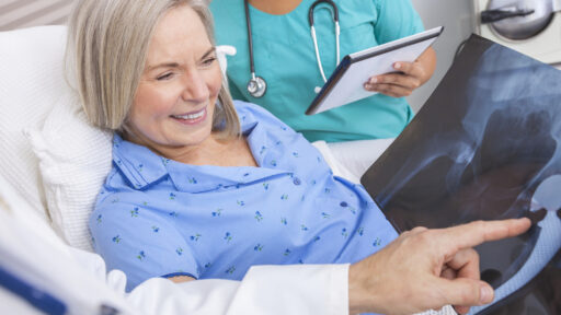 woman looking at her x-rays post-surgery