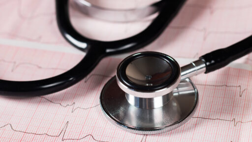 Medical concept. Cardiogram with stethoscope on table, closeup