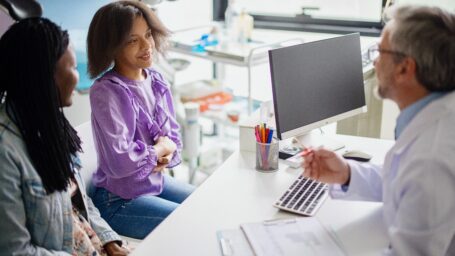 doctor talking to teen and patient