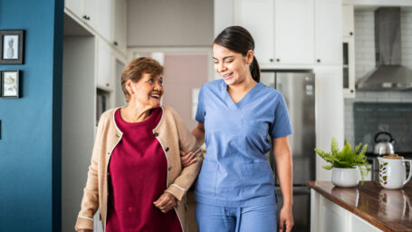 therapist helping a woman walk