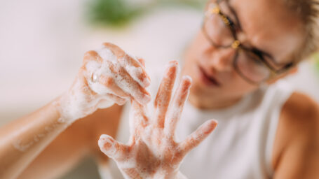 Woman obsessively washing her hands.