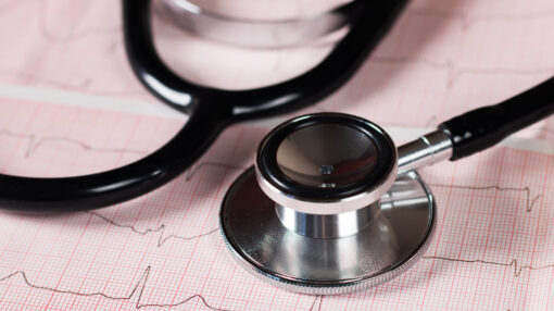 Medical concept. Cardiogram with stethoscope on table, closeup
