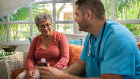 A nurse explaining medications to a patient