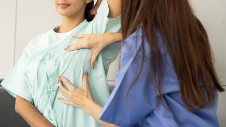 Woman giving a breast exam