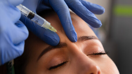 Woman getting injections to lift her brow