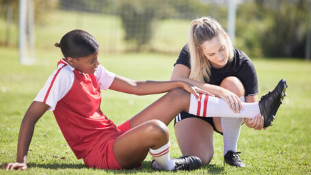 female soccer player with an athletic trainer