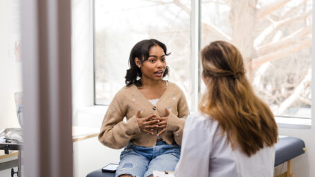 A teen girl talking to a therapist