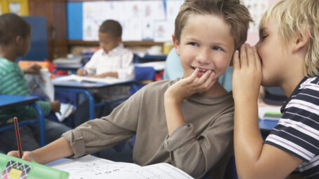 two boys talking during class