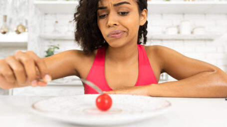 a woman eating a tomato