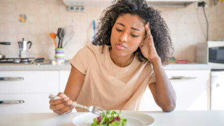 a girl looking at a salad