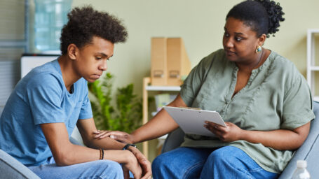 a therapist talking to a teen boy